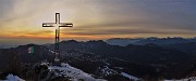 72 La bella croce di vetta Cornagera (1311 m) baciata dal sole con vista verso la Val Serina